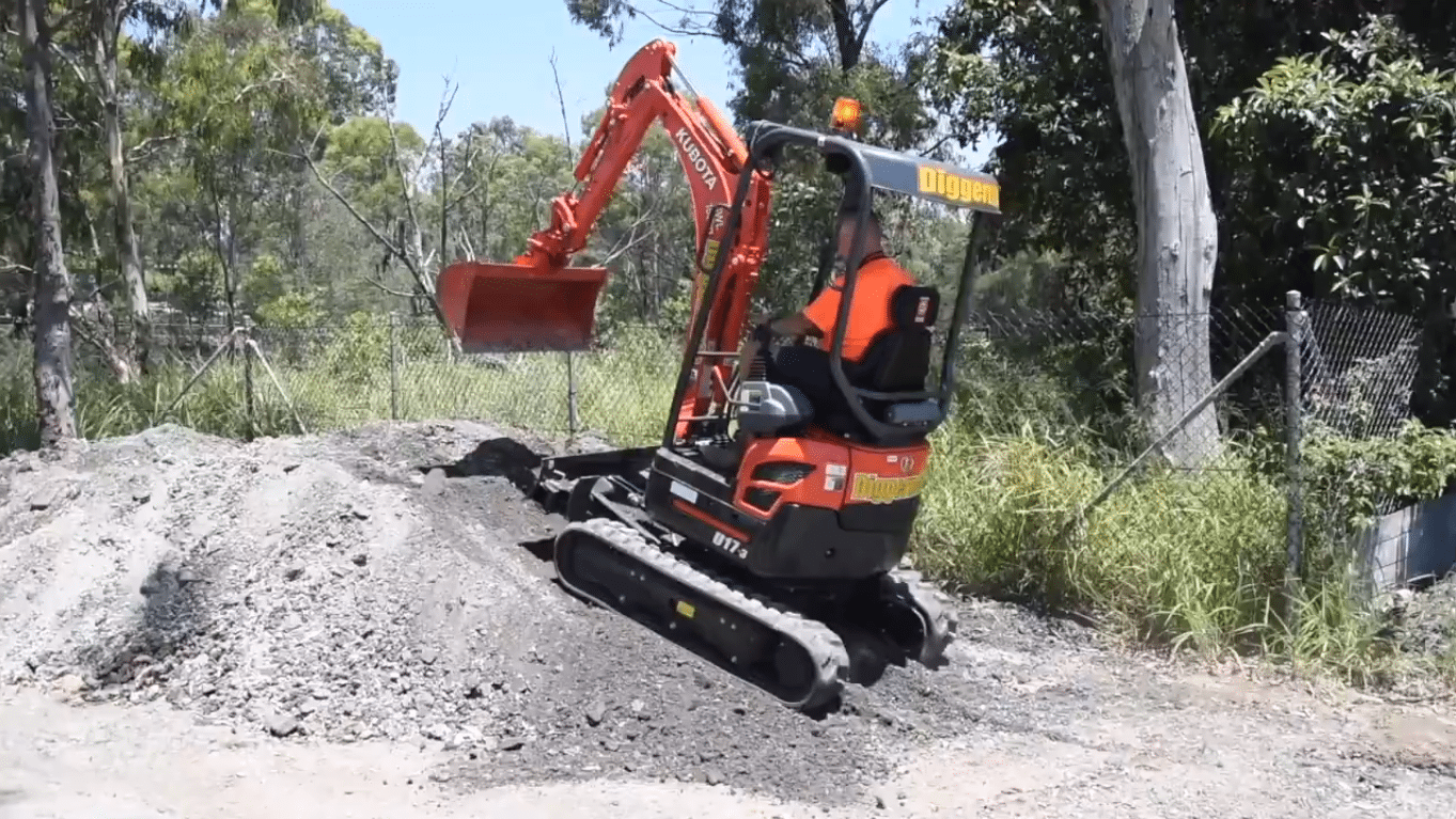 Preparing to climb a slope with a mini excavator